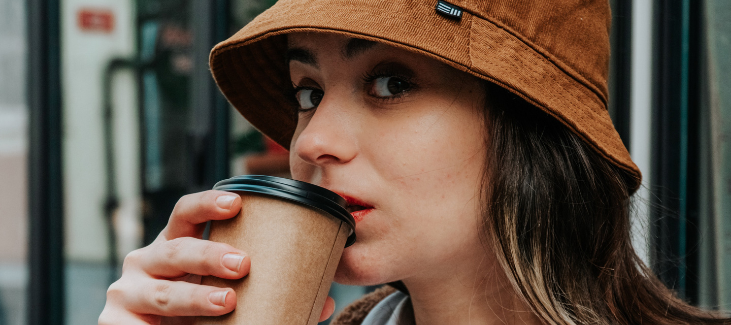 Close up of a women drinking a cup of coffee